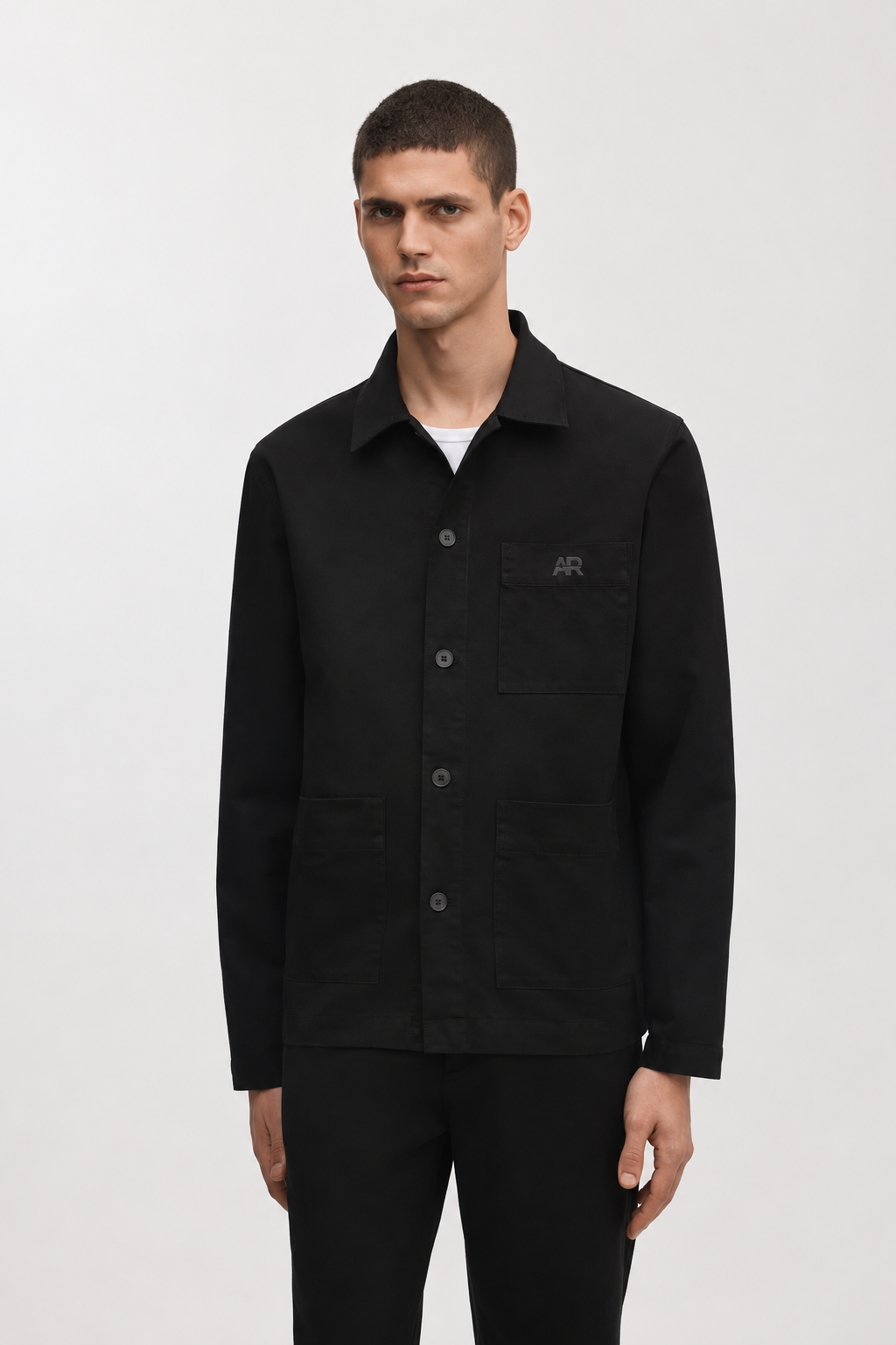 Model wearing the black Structured Overshirt with a tonal AR chest logo over a white tee